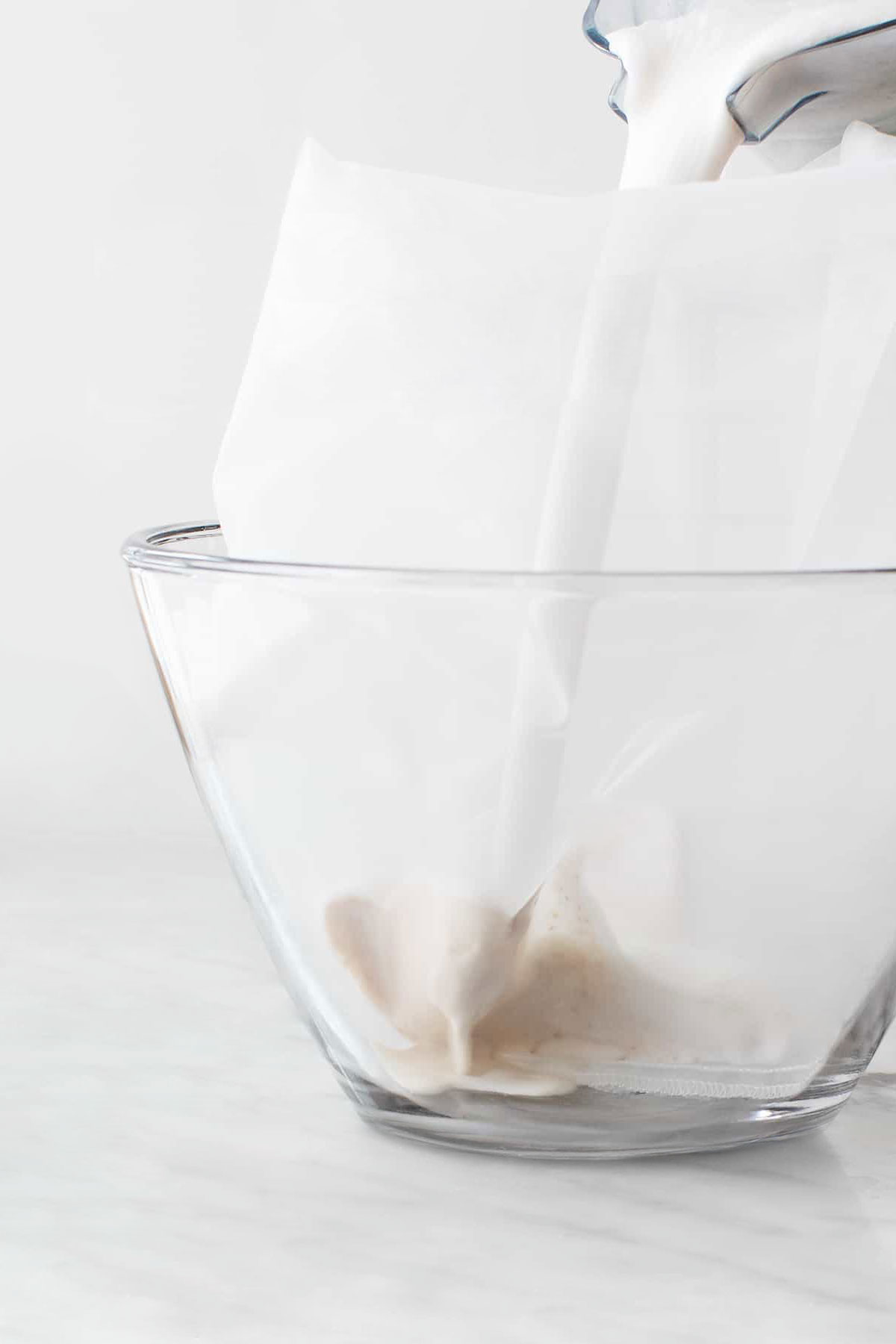 straining almond milk