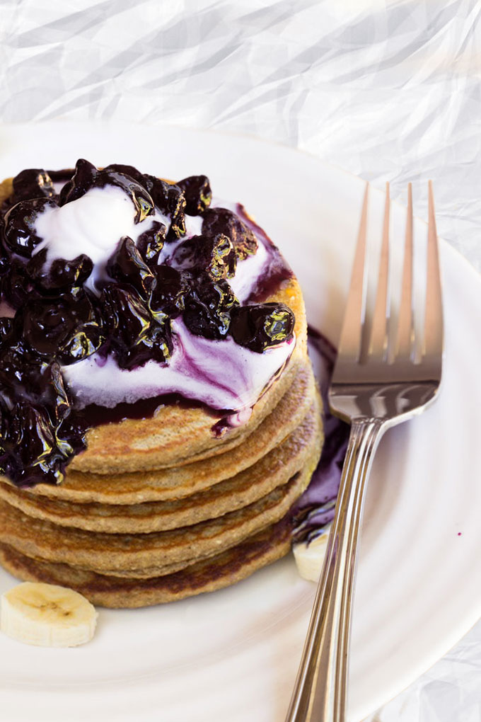 raw pancakes with blueberry sauce and whipped cream
