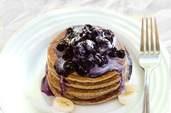 raw pancakes - vegan, paleo with blueberry sauce and coconut whipped cream