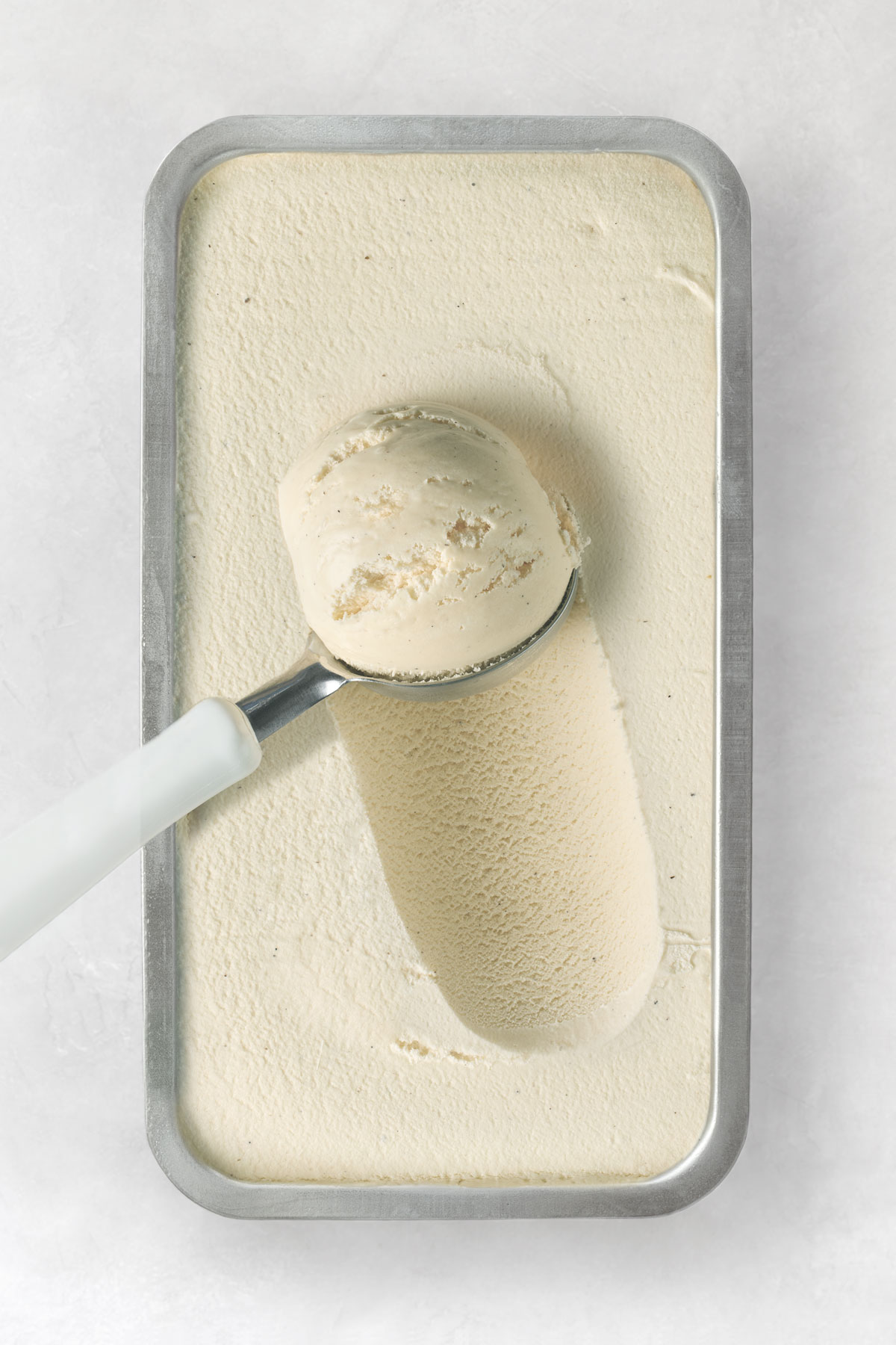 scooping vegan vanilla ice cream